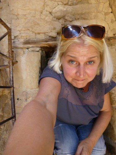 H crawling through entrance  to ruins, selfie